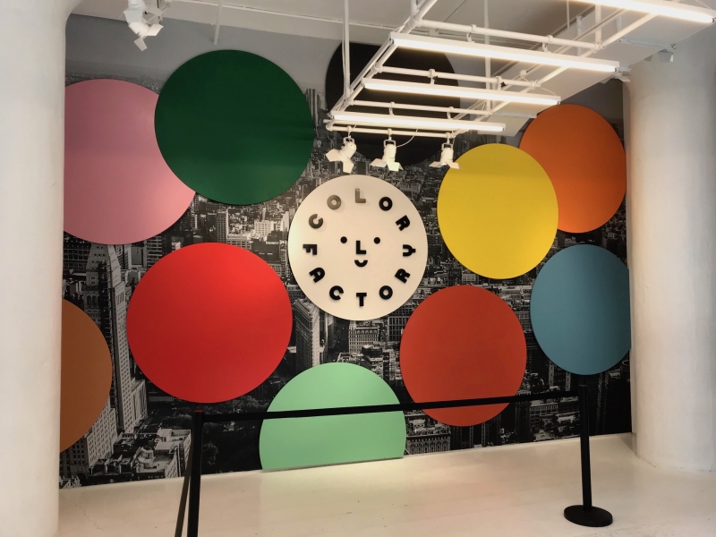 At Color Factory in NYC , entry way graphic wallpaper and dimensional circles.