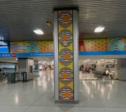 Vinyl graphics are printed and installed to wrap columns and overhead spaces in art installation in Penn Station , NYC