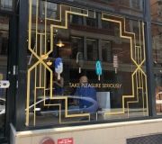 Metallic gold cut vinyl creates eye catching window display for pop up store