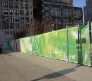 Art installation uses vinyl mesh to cover fence at construction site