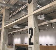 Wayfinding signage screen printed on concrete columns corporate interiors NYC