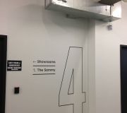 Wayfinding signage produced with custom stencil and hand painted by Color X