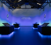 custom fabricated desk pods with swivel screens and LED lighting placed on top of color matched floor vinyls 
