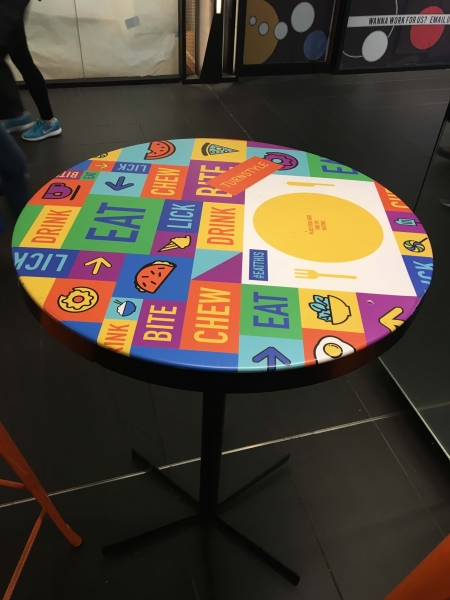 Vinyl can be used in many exciting ways . here, table to pis wrapped with vinyl for branding .