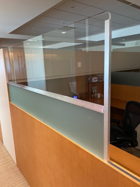 Half inch polished plexiglass divider added to existing partition