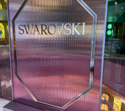 Fabricated in store display for luxury retailer  fluted vinyl mounted to clear acrylic with metallic dimensional letters with metal base. 