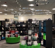 Hanging display rings fabricated with mirror vinyl wrap .  Roll out to all stores .